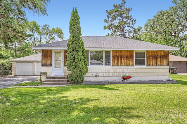 11352 Olive St NW, Coon Rapids, MN 55448 - view of front of house featuring roof with shingles, a front lawn, and a detached garage