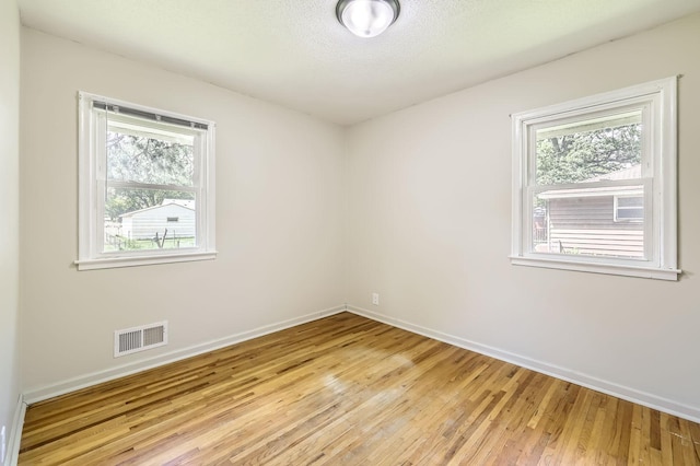 11352 Olive St NW, Coon Rapids, MN 55448 - spare room with baseboards and light wood finished floors