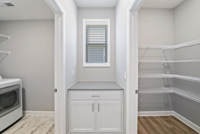 washroom featuring washer / dryer and baseboards