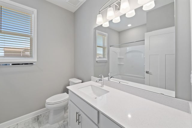 bathroom featuring marble finish flooring, baseboards, vanity, and toilet