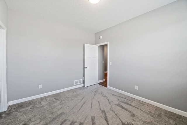 carpeted spare room with baseboards