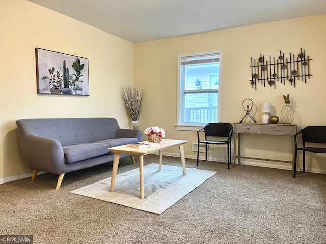 living area with baseboards and carpet