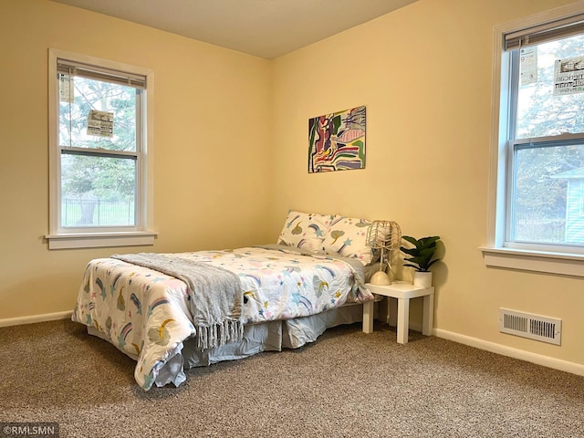 bedroom with baseboards, visible vents, and carpet floors
