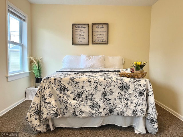 bedroom featuring carpet flooring, baseboards, and multiple windows