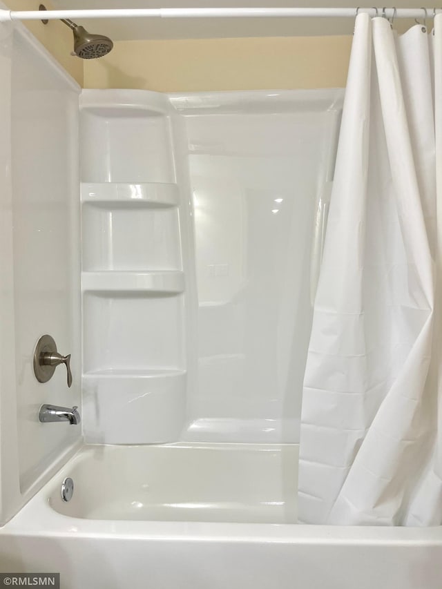 bathroom with shower / tub combo with curtain