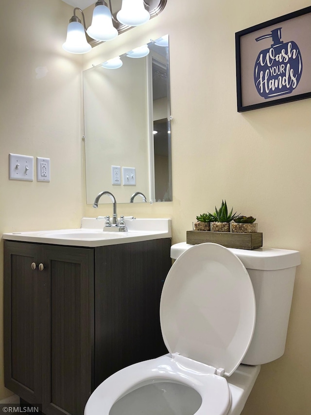 bathroom with toilet and vanity