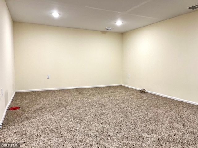 empty room featuring recessed lighting, carpet, and visible vents