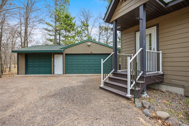 view of property exterior with an outbuilding, dirt driveway, and a garage