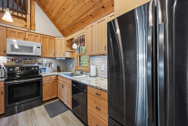 kitchen featuring a sink, freestanding refrigerator, range with electric cooktop, white microwave, and dishwasher