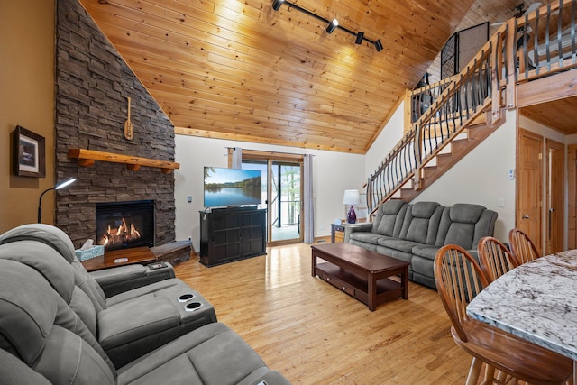 living area with wood ceiling, high vaulted ceiling, and track lighting