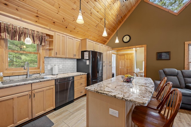 kitchen featuring a sink, freestanding refrigerator, high vaulted ceiling, light brown cabinetry, and stainless steel dishwasher