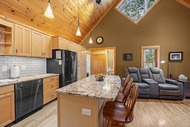 kitchen with freestanding refrigerator, stainless steel dishwasher, light brown cabinets, and high vaulted ceiling