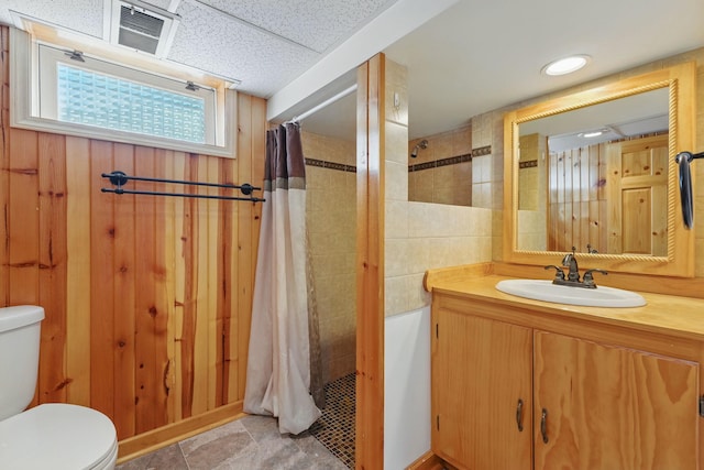 bathroom featuring toilet, tiled shower / bath combo, vanity, and visible vents