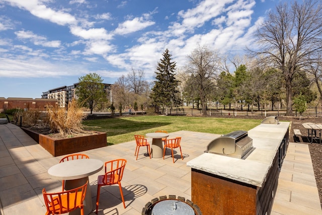 702 1st St Unit 521, Minneapolis, MN 55401 - view of patio featuring area for grilling, outdoor dining area, and fence