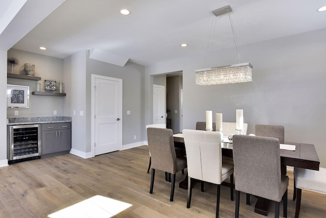 3542 Leroy St, Deephaven, MN 55391 - dining space featuring beverage cooler, light wood-type flooring, baseboards, recessed lighting, and bar area