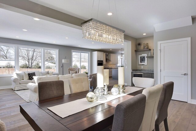 3542 Leroy St, Deephaven, MN 55391 - dining room with a chandelier, light wood finished floors, recessed lighting, beverage cooler, and baseboards
