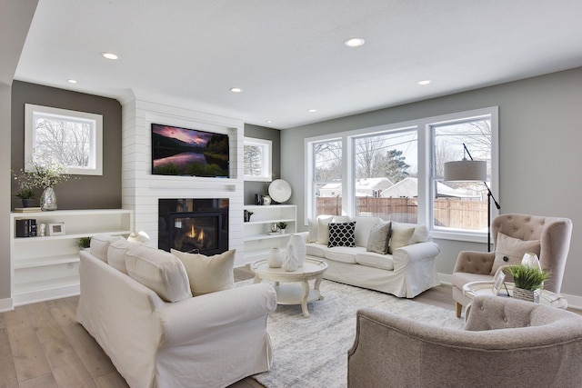3542 Leroy St, Deephaven, MN 55391 - living room with light wood-type flooring, recessed lighting, a large fireplace, plenty of natural light, and baseboards