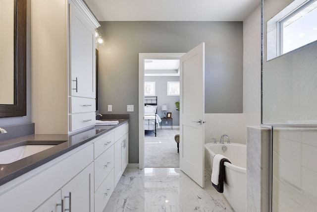 3542 Leroy St, Deephaven, MN 55391 - ensuite bathroom with a freestanding tub, plenty of natural light, double vanity, and marble finish flooring