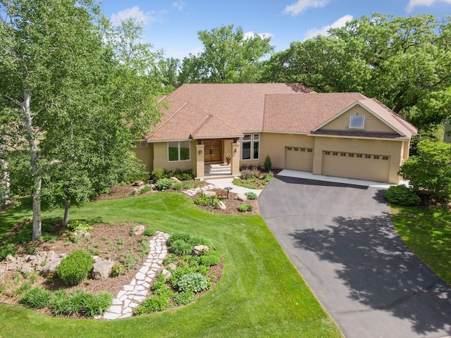1656 Isabella Pkwy, Chaska, MN 55318 - ranch-style home featuring asphalt driveway, a garage, a front yard, stucco siding, and roof with shingles