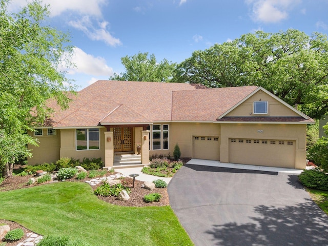 1656 Isabella Pkwy, Chaska, MN 55318 - view of front of property featuring driveway, a garage, a front yard, and stucco siding