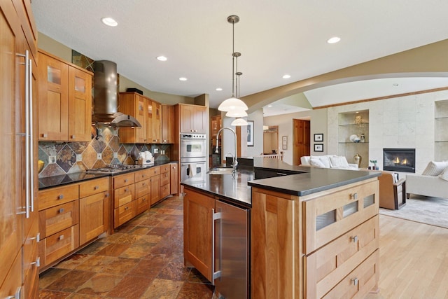 1656 Isabella Pkwy, Chaska, MN 55318 - kitchen with wine cooler, dark countertops, a sink, appliances with stainless steel finishes, and island range hood