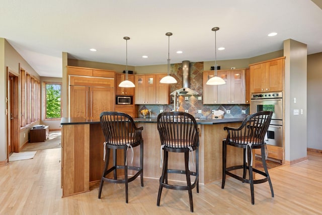 1656 Isabella Pkwy, Chaska, MN 55318 - kitchen with built in appliances, dark countertops, backsplash, wall chimney exhaust hood, and light wood finished floors