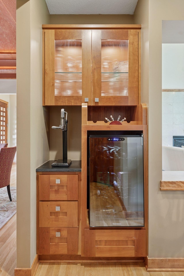 1656 Isabella Pkwy, Chaska, MN 55318 - bar featuring light wood-type flooring, wine cooler, and baseboards