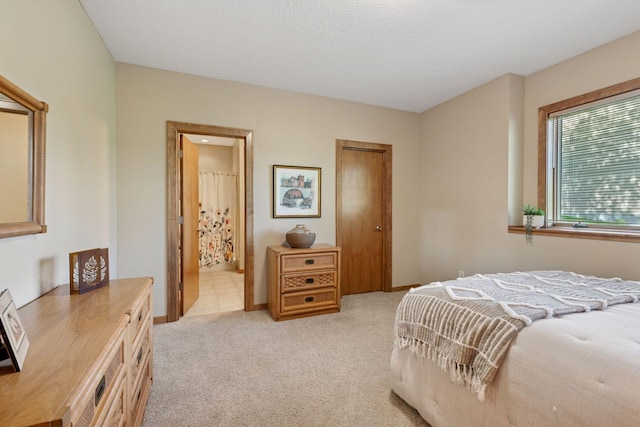 1656 Isabella Pkwy, Chaska, MN 55318 - bedroom featuring light carpet, baseboards, and ensuite bath