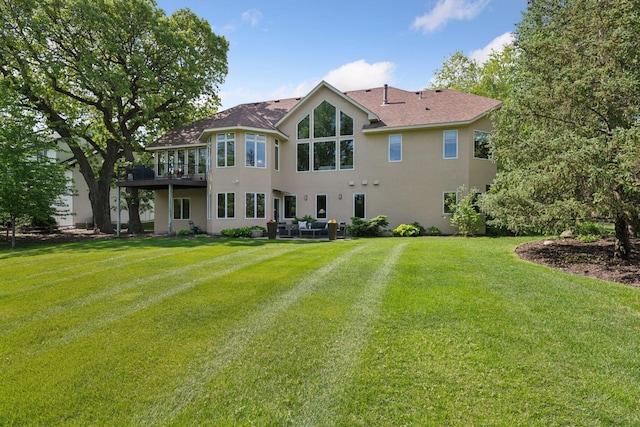 1656 Isabella Pkwy, Chaska, MN 55318 - back of property with stucco siding, a lawn, an outdoor living space, and a shingled roof
