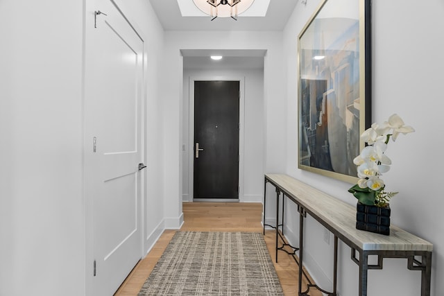 entryway featuring baseboards and light wood-style floors