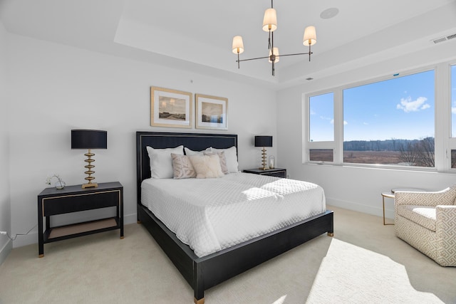 bedroom featuring light colored carpet, an inviting chandelier, baseboards, a tray ceiling, and visible vents