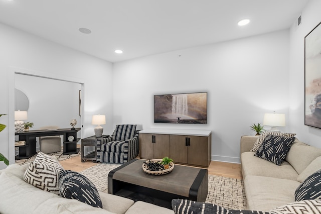 living area featuring recessed lighting, light wood finished floors, baseboards, and visible vents