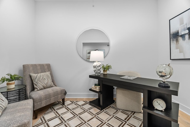 office area featuring baseboards and light wood-type flooring