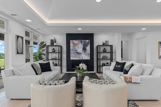 living area featuring visible vents, recessed lighting, and light wood-style flooring