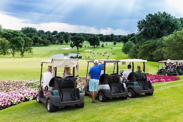 view of property's community featuring a lawn and view of golf course