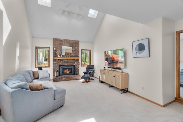 living room with a skylight, light carpet, baseboards, and a fireplace