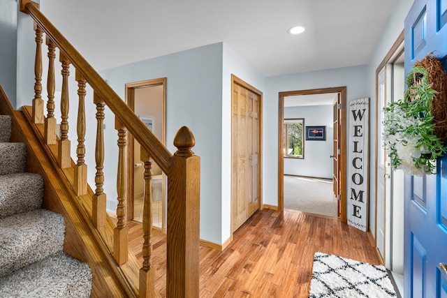 entrance foyer featuring light wood-type flooring, recessed lighting, stairs, and plenty of natural light