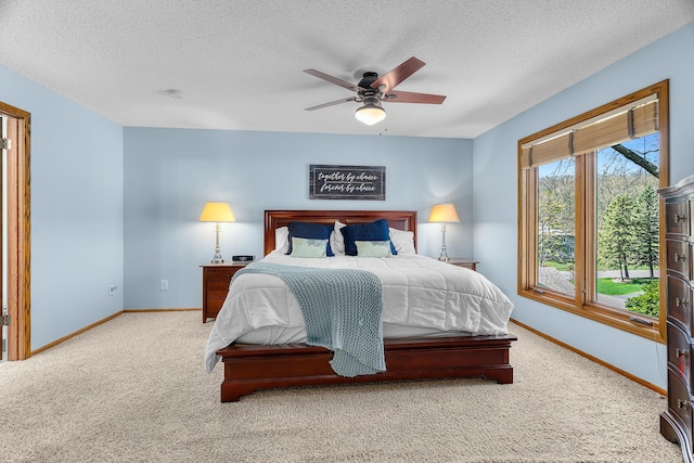 carpeted bedroom with baseboards, a ceiling fan, and a textured ceiling