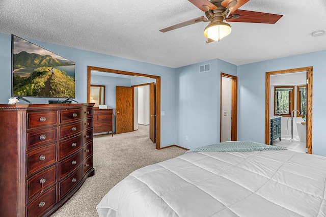 bedroom featuring visible vents, light carpet, baseboards, a textured ceiling, and a ceiling fan