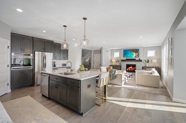 kitchen featuring recessed lighting, a sink, appliances with stainless steel finishes, and light countertops