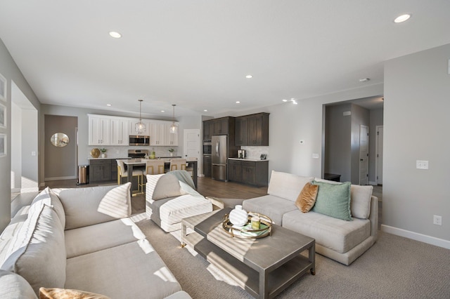 living area with recessed lighting and baseboards