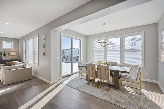 dining space featuring baseboards, recessed lighting, light wood finished floors, and a chandelier