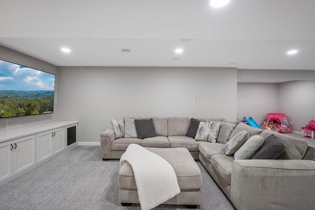 living room featuring recessed lighting, baseboards, and light colored carpet