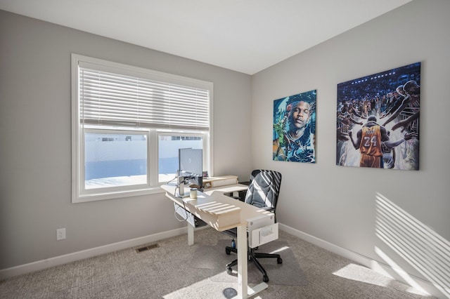 carpeted office space with baseboards and visible vents