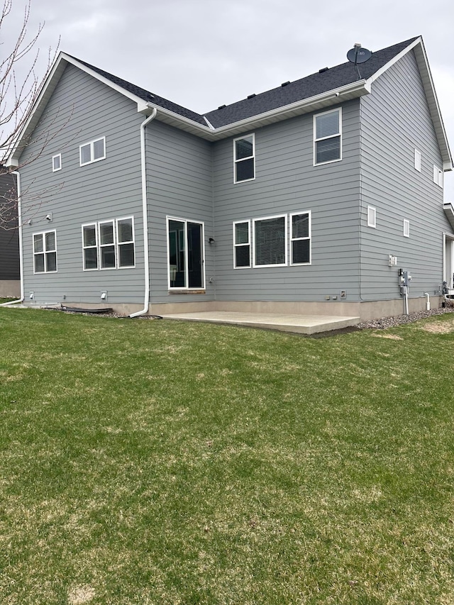back of house with a lawn and a patio area