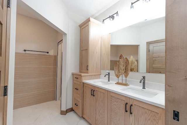 bathroom featuring a sink, double vanity, and marble finish floor