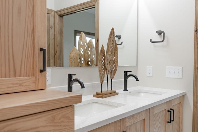 full bathroom with a sink and double vanity