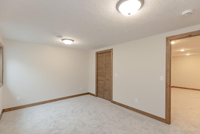 unfurnished bedroom with carpet floors, baseboards, and a closet