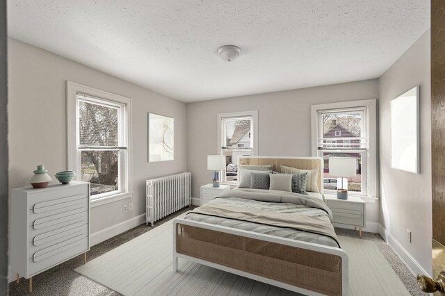 bedroom featuring radiator, baseboards, carpet, and a textured ceiling