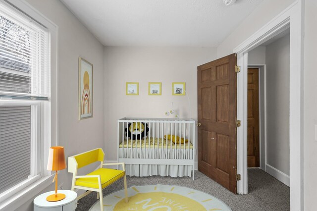 carpeted bedroom featuring baseboards